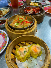 Delicious Chinese Foods, Dim Sum, Chicken Feet, and Tofu on Bamboo Tray