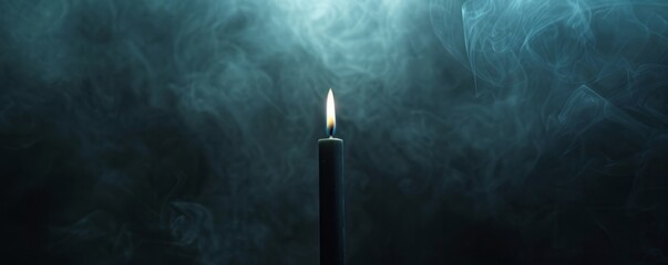 black candle on a dark background with fog. - obrazy, fototapety, plakaty