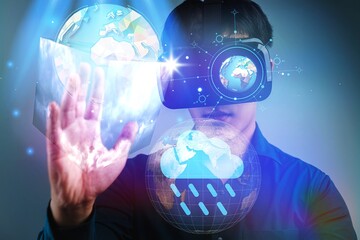 A man is wearing a virtual reality headset and is pointing at a globe. Concept of wonder and excitement as the man explores the world through the VR headset