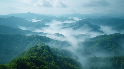   Aerial view of a mountain range in a foggy valley