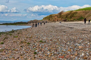 people on the stone beach in Heysham