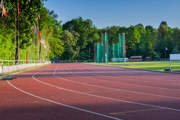 Sports stadium, athletics treadmill for runners at an outdoor stadium, stands for fans, Poland, Bialystok - 778435927
