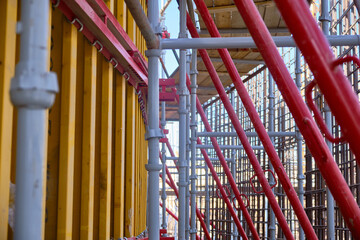 Vertical panel formwork, push-pull jacks and scaffoldings of reinforced concrete walls under construction. Structures for cast in place reinforced concrete