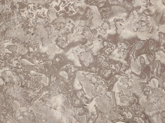 Patterns on a sandy beach after low tide on the ocean. Abstract sand nature background. Close-up of patterns on the sand surface from sea water after low tide