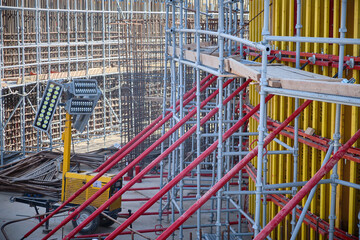Vertical panel formwork, push-pull jacks and scaffoldings of reinforced concrete walls under construction. Structures for cast in place reinforced concrete