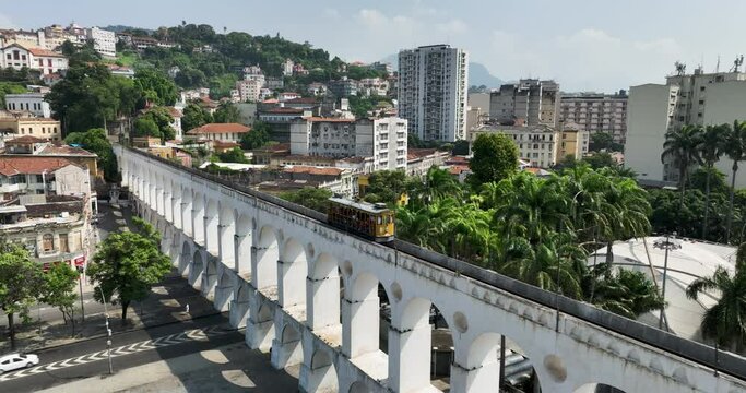 Aerial view of Carioca Aqueduct bridge with tram heading towards Santa Teresa neighborhood in Rio de Janeiro, Brazil 