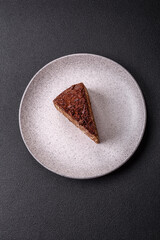 Delicious fresh cheesecake cake or snickers with cream and nuts on a ceramic plate