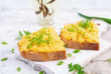 Scrambled eggs with herbs and toasts. Delicious breakfast with eggs and herbs