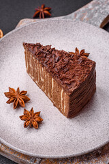 Delicious fresh cheesecake cake or snickers with cream and nuts on a ceramic plate