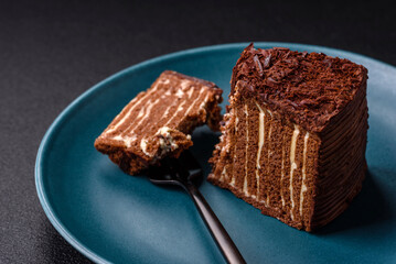 Delicious fresh cheesecake cake or snickers with cream and nuts on a ceramic plate