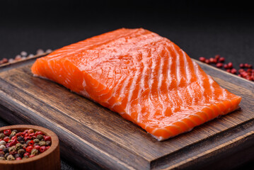 Fresh raw salmon steak with spices and herbs prepared for grilled baking