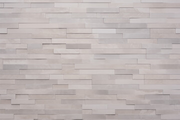 A wall made of white tiles with a gray border