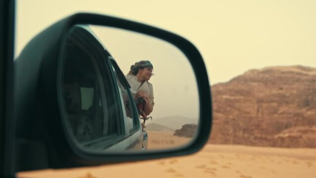 Woman in the Side Mirror Reflection on a desert ride