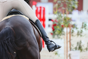 Influence with body, legs and hands. Riders active leg close-up. Equestrian Sports, Show Jumping...