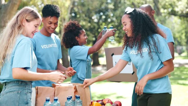 Group, friends and volunteer with food donation, community service and distribution with nonprofit. People volunteering, teamwork or poverty support with NGO, charity or healthy snack or water bottle