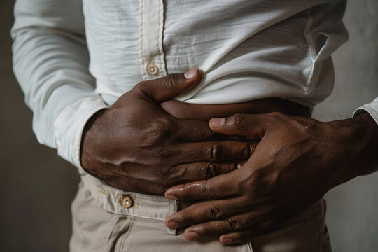 man clutching his stomach in pain