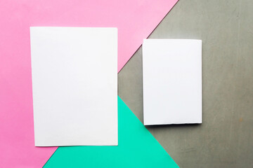 Two white mockup blanks on geometric green, pink and gray background. Copy space for the text. Minimal concept