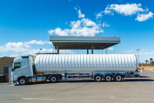 Tanker truck for transporting gases that also has a gas tank as fuel to circulate, side view.
