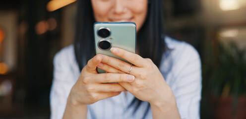 Hands, woman and phone for texting, closeup or happy for funny video, meme or comic web blog. Girl, Japanese person and smartphone for typing, scroll or click for reading notification on social media