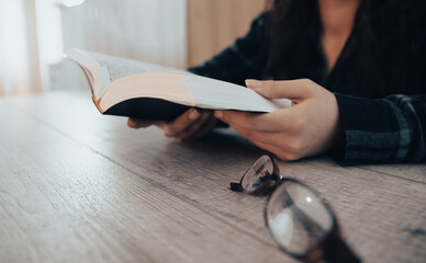 Woman reading holy book, hands close up. stock photo