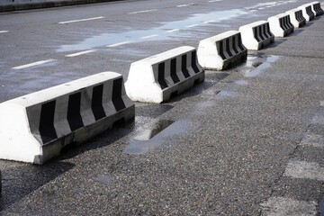 Concrete barriers on the wet road.