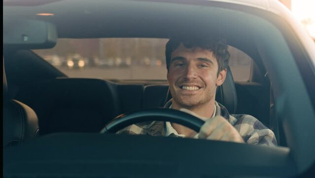 Happy smiling Caucasian business man male driver driving new modern electric car handsome guy vehicle owner hold steering wheel in luxury auto drive enjoy traveling road route city automobile traffic