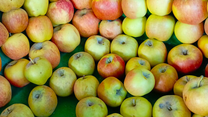 red, green apples in a market