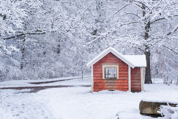 Little red wooden play house covered in dense snow in sweden gothenburg