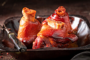 Tasty and grilled Schweinshaxe baked in casserole. - obrazy, fototapety, plakaty