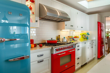 A retro-inspired kitchen with bold colors, chrome accents, and vintage appliances combined with modern conveniences.