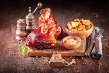 Grilled roasted Schweinshaxe served with potatoes and pickled cabbage. - obrazy, fototapety, plakaty