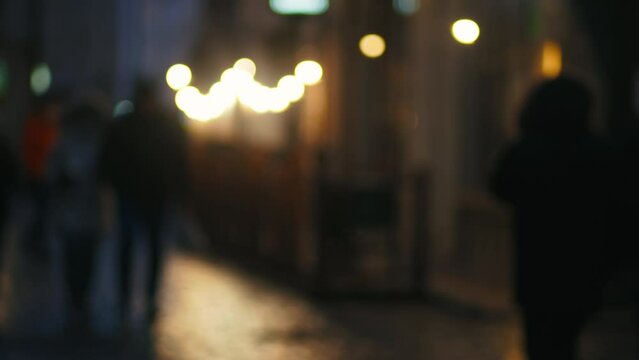 Rainy City Blur: A defocused glimpse into the wet nocturnal streets, where lights shimmer and figures move in a dance of urban life.