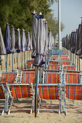 Beach deck chairs and umbrella in the morning at Cha-am Beach.  Located at Phetchaburi Province in Thailand.