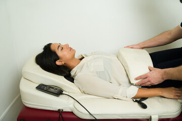 Relaxed woman at the doctor's getting a massage during andullation treatment massage - 778536176