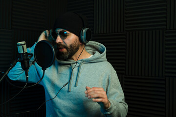 Recording artist singing a song in a soundproof studio