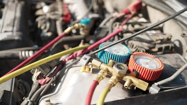 A car engine with two blue and red gauges