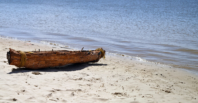 Landscape profile view of Australian indigenous aboriginal Swamp Mahogany bark canoe on the Noosa River