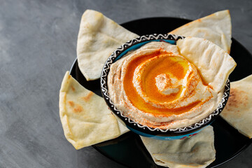 Hummus Dip with Pita Bread on Black Plate, Ramadan Food, Copy Space