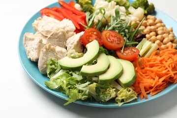 Balanced diet and healthy foods. Plate with different delicious products on white table, closeup