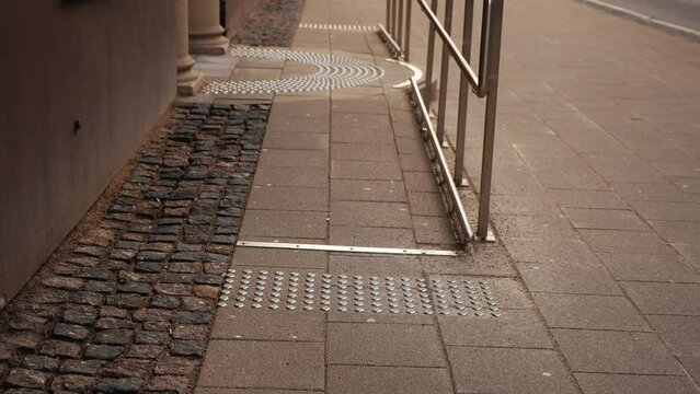 Cityscape inclusivity: Elevated vantage point capturing tactile pavement with braille indicators, ensuring accessibility in the urban landscape
