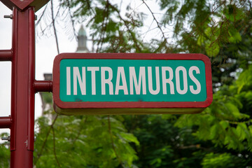 Intramuros road sign with green background. - 778566119