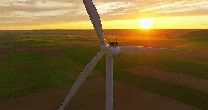 Establishing shot of windmills farm. Power energy production. Wind turbines. Large wind turbines with blades in field aerial view, sunset