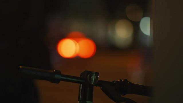 a blurry picture of a person riding a bike at night
