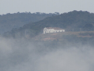 Fototapeta premium A small church on top of a mountain in a small town