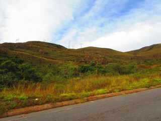 A road with a beautiful landscape behind on top of a mountain