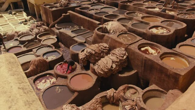 Top view of worker Soaking leather into the Dye Pool
