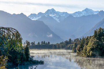Lake Matheson : Iconic View of the Aoraki Mount Cook and Mount Tasman mountains reflected on the still water, West coast, New Zealand