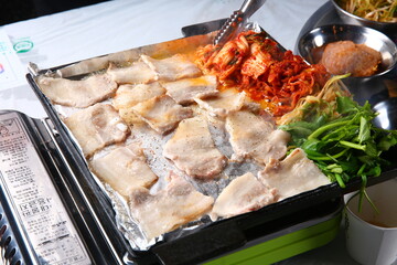 Pork belly that is cooked on a Korean-style grill