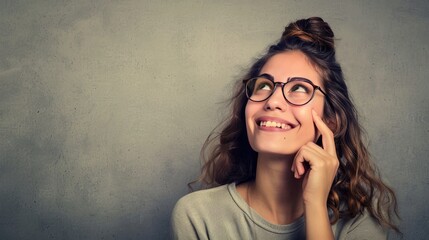 Young woman with glasses, smiling, thinking, thought, open space, textured wall