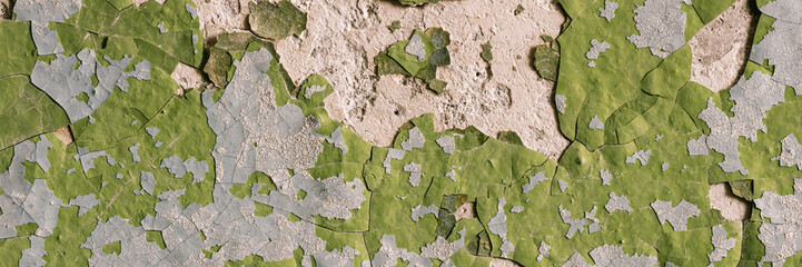 Peeling paint on the wall. Panorama of a concrete wall with old cracked flaking paint. Weathered rough painted surface with patterns of cracks and peeling. Wide panoramic grungy texture for background - 778597381